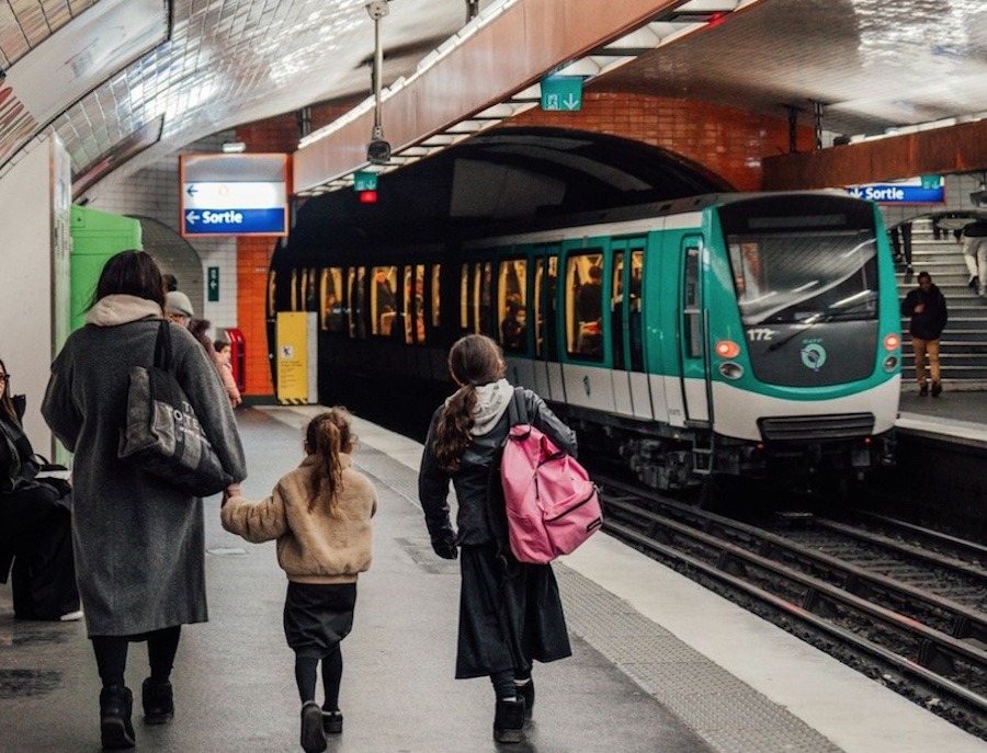 This is an image of people waiting for an underground train in the station.