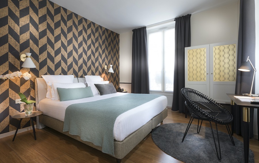 This is an image of a clean hotel room with minimalistic and elegant furniture.