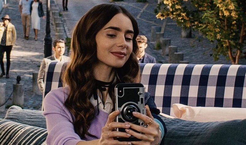 This is an image of Lily Collins from Emily in Paris taking a selfie.