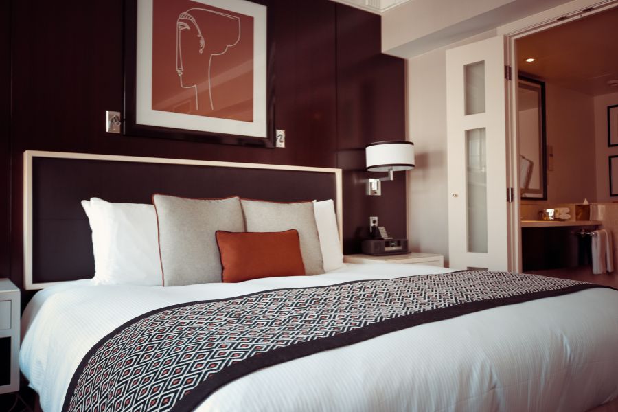 This is an image of a hotel room in Paris with a big double bed and art.