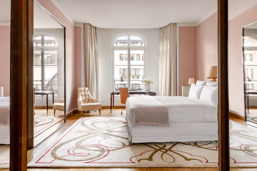 This is an image of a fancy hotel room in Paris with red colour accents.