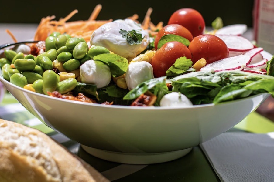 A white bowl filled with a summer salad.