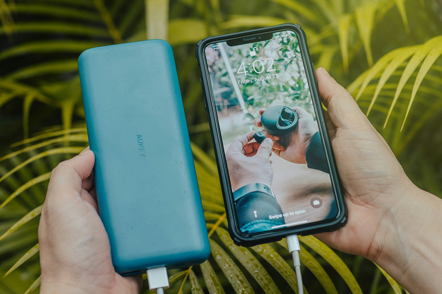 Portable power bank charging a smartphone, one of the most useful Paris travel accessories for long days of sightseeing.