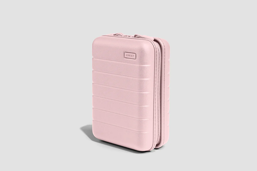 Pink travel cable organiser, one of the handy Paris travel accessories for keeping chargers and small tech neatly packed.