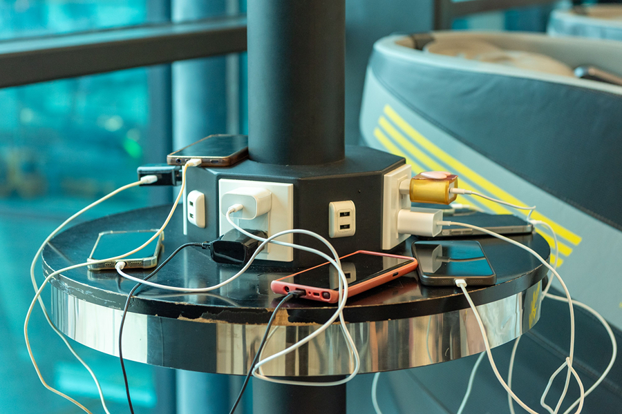Phones and devices charging with travel adapters, useful Paris travel accessories for keeping your electronics powered throughout your trip.