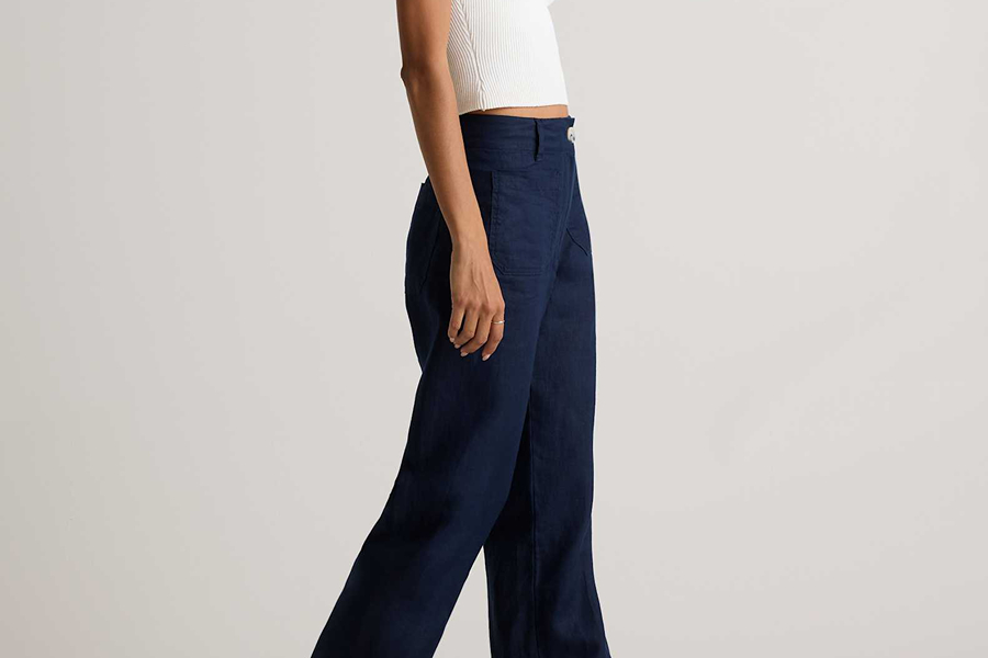 Navy wide-leg trousers styled with a white top, ideal for a relaxed Parisian wardrobe.