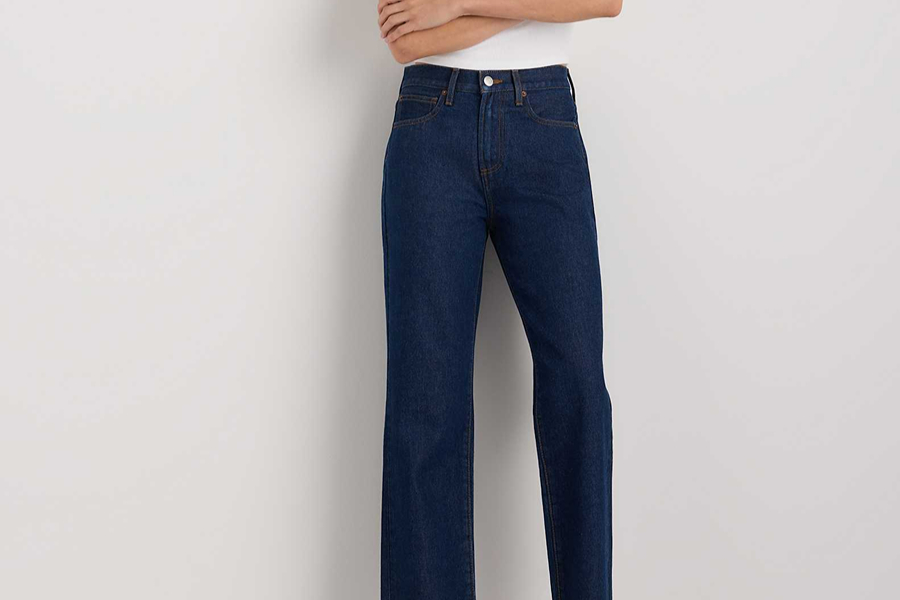 Dark indigo straight-leg jeans with a white top, a simple look for how to blend in with Parisians.