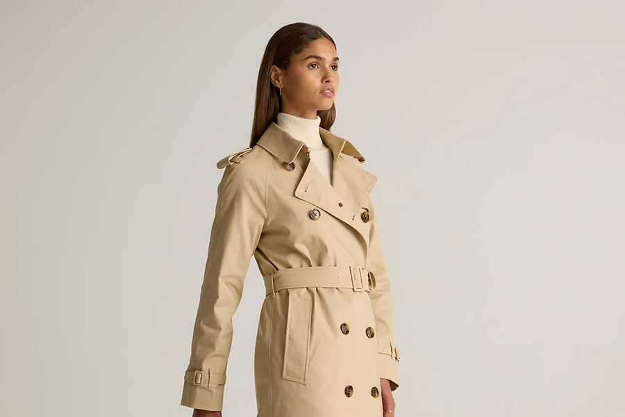 Woman wearing a beige belted trench coat, a timeless staple for how to blend in with Parisians.
