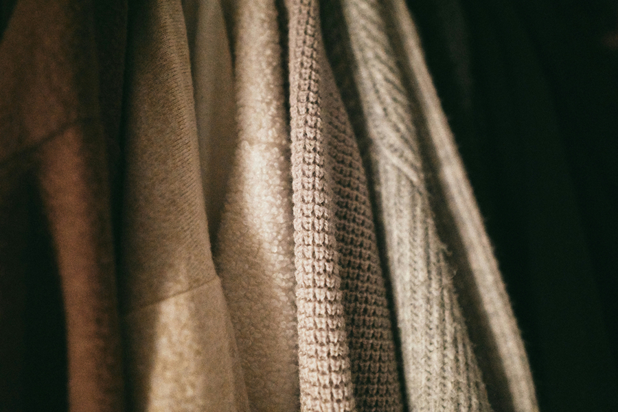Close-up of neutral-toned scarves, a classic accessory for building a Parisian-inspired wardrobe.