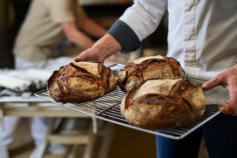 Freshly baked loaves at Boulangerie La Parisienne, one of the places to eat with kids in Paris.