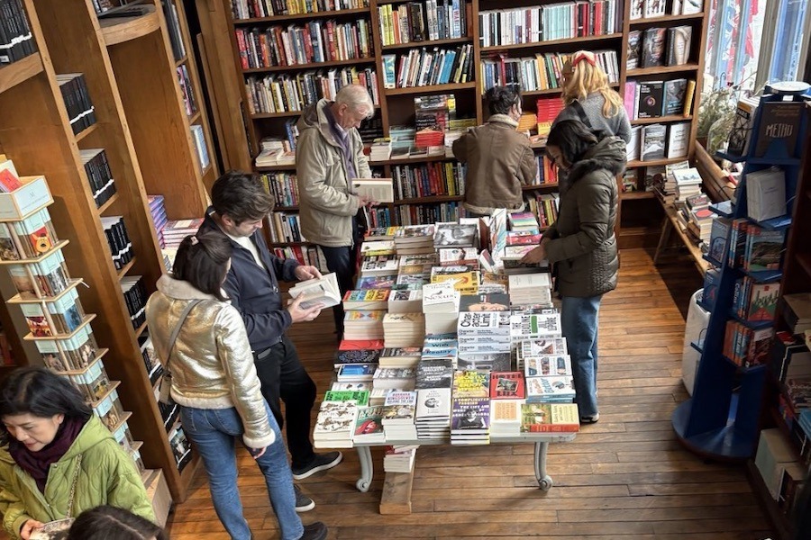 This is a bird's eye image of people milling around a bookstore full of wonderful books.