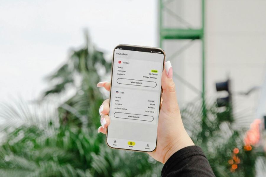 This is an image of someone using SimLocal and holding up their phone to show the phone usage page.