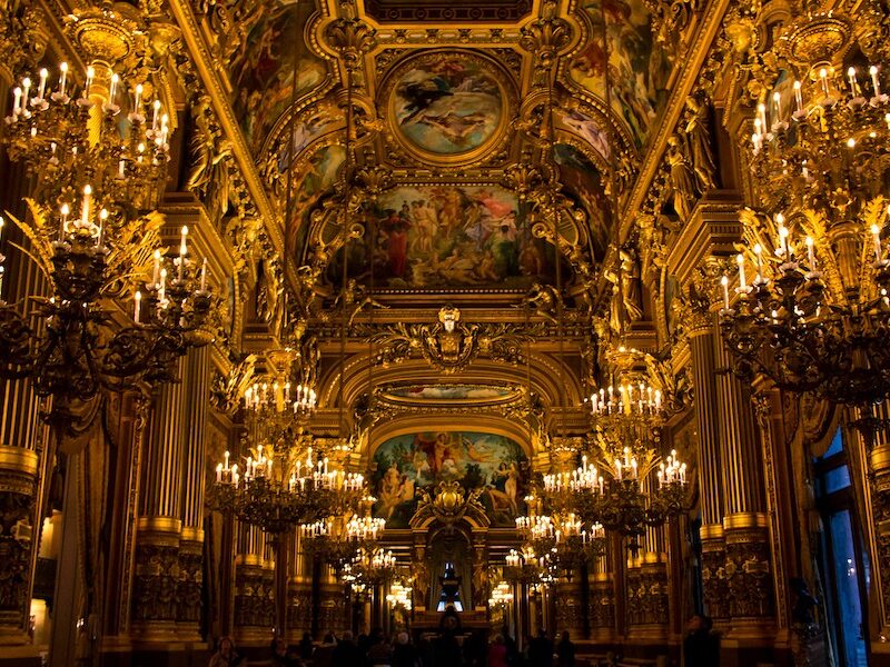This is a picture of the inside of the Opera Garnier with all its gold trimmings and extensive lights and candles.