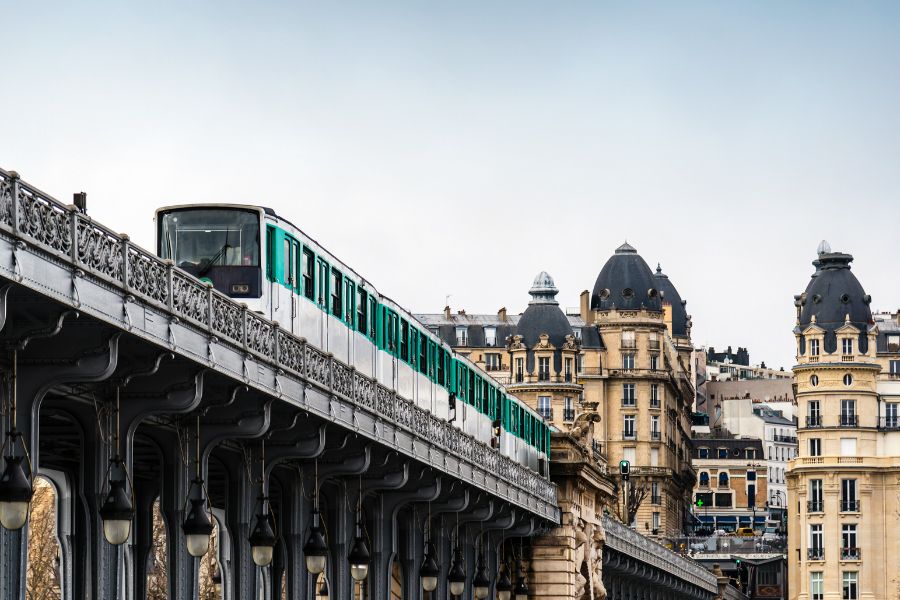 This is an image of a train going across a bridge in Paris.