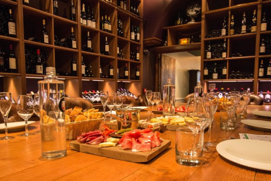 This is an image of a nicely decorated table full of crockery. There are also multiple charcuterie boards laid out in the middle.