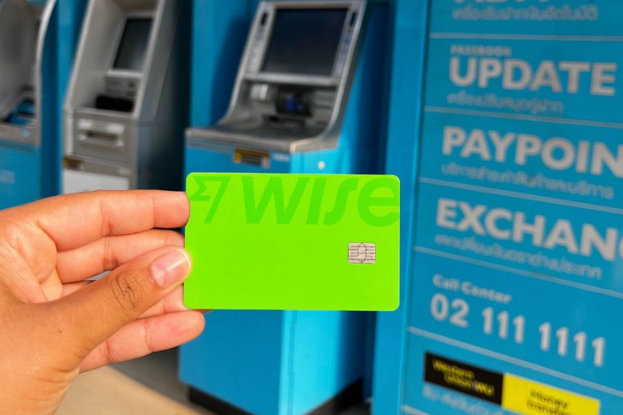 This is a picture of someone holding up a bright green Wise card.