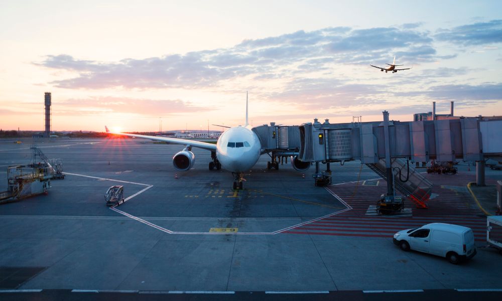 This is an image of an airline tarmac with a plane getting boarded.