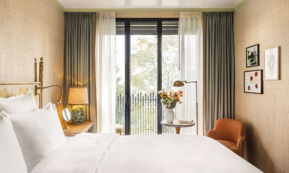 This is an image of a light-filled room with flowers, and lots of balcony space.