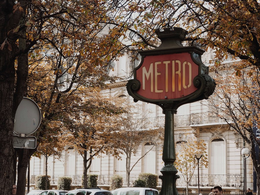 This is a picture of the metro sign in Paris. You see these on streets where there is a metro underneath.